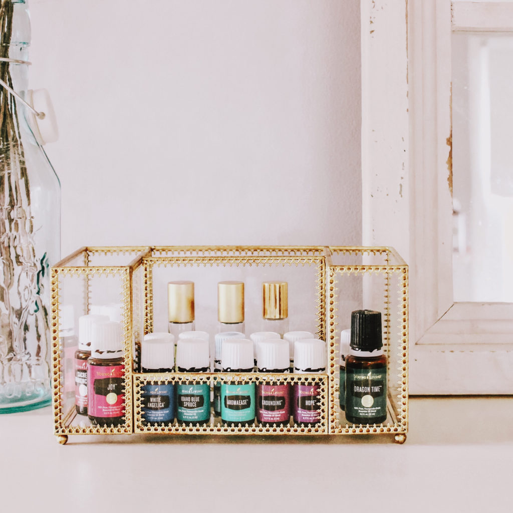 essential oils in gold display case sitting on shelf
